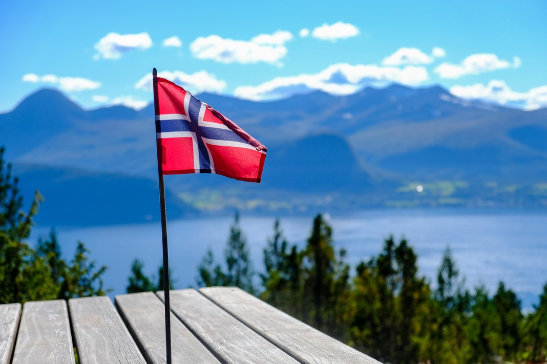 norway flag with a fjord background
