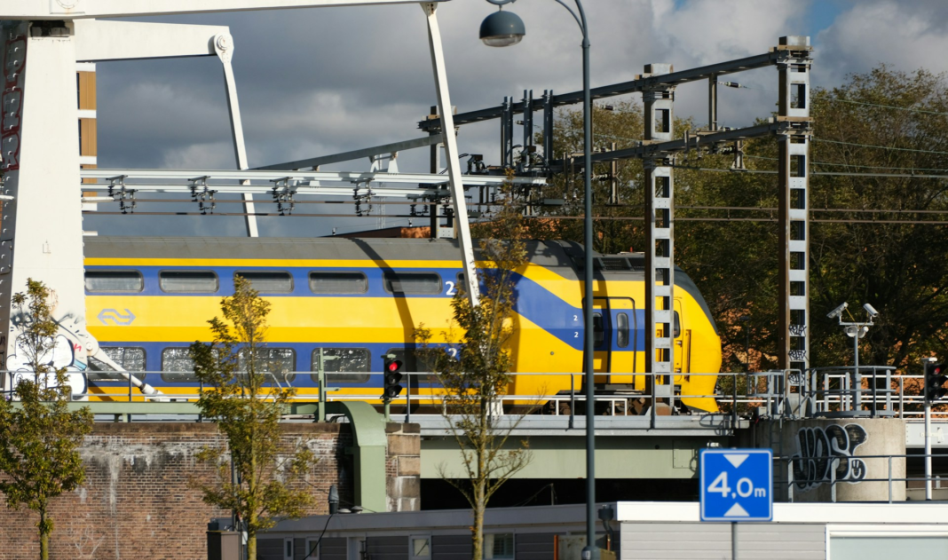 yellow and blue train traveling over a bridge