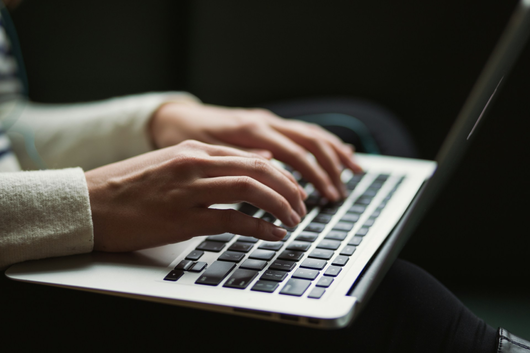 person typing on keyboard